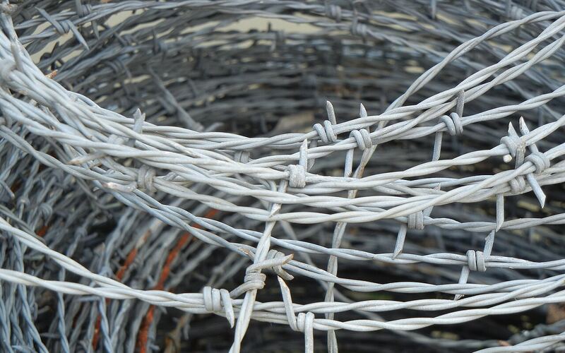 Close-up of a roll of galvanized barbed wire