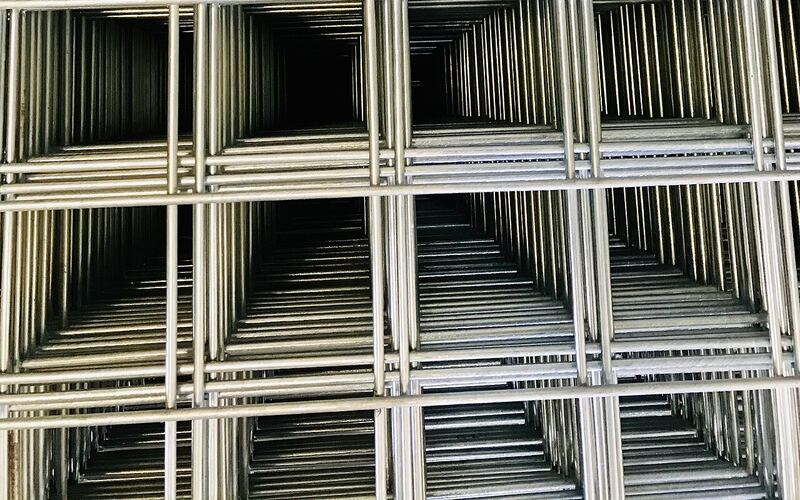 Stack of galvanized welded wire mesh panels with square openings